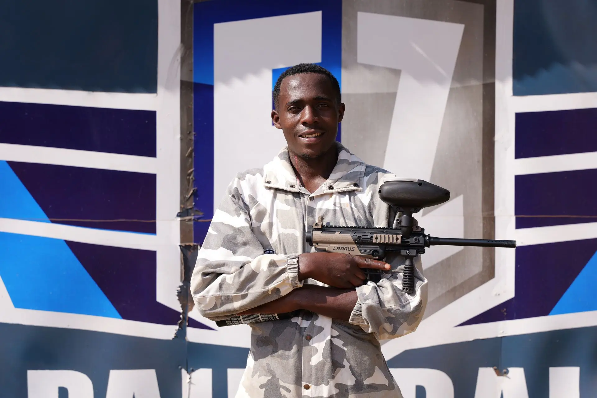Gilbert K holding a paintball marker at the FZ Paintball range.